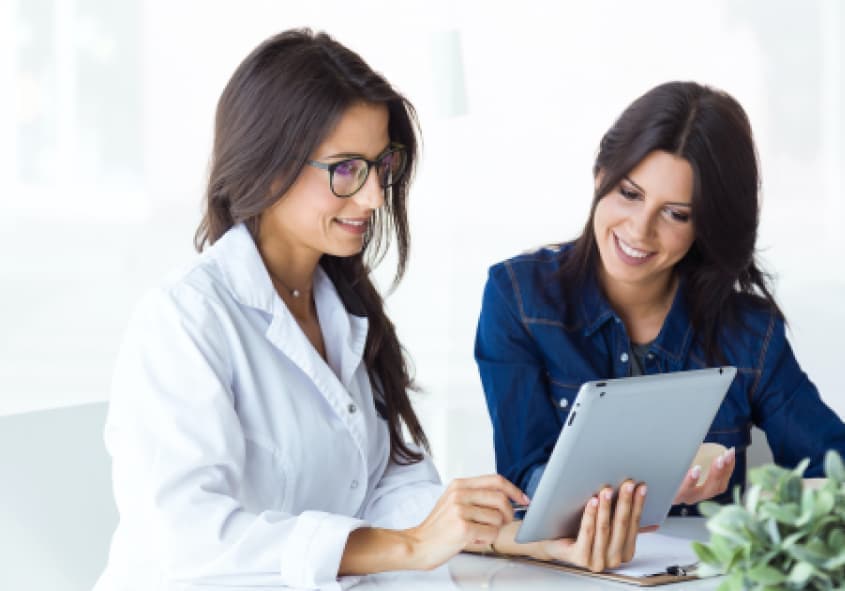 Two women looking at the tablet